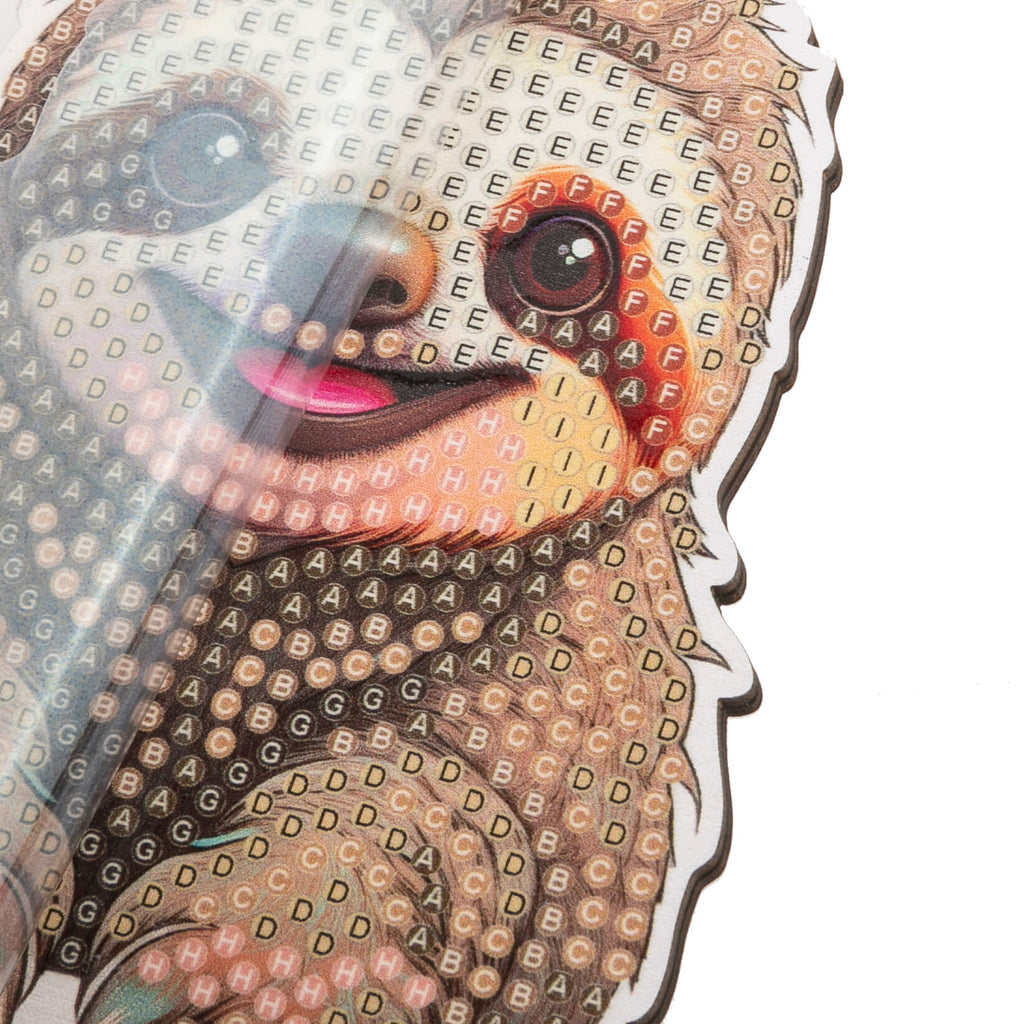 close up view of Sloth Crystal Art Wildlife Buddy, highlighting the coded adhesive template showing required placement of crystals