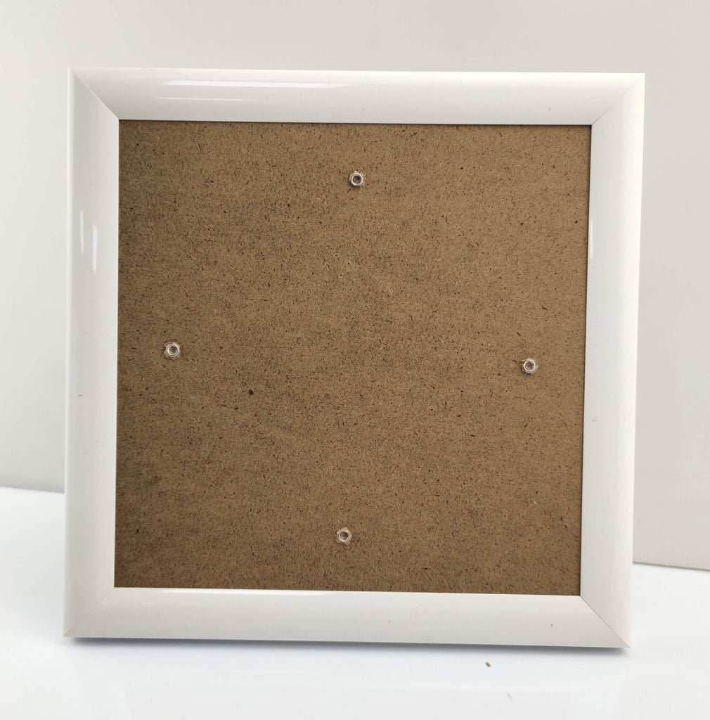 White Craft Buddy Greetings Card frame with brown backing board, photographed on table against white background