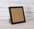 Black Crystal Art Greetings Card Frame, photographed on table against a white brick background