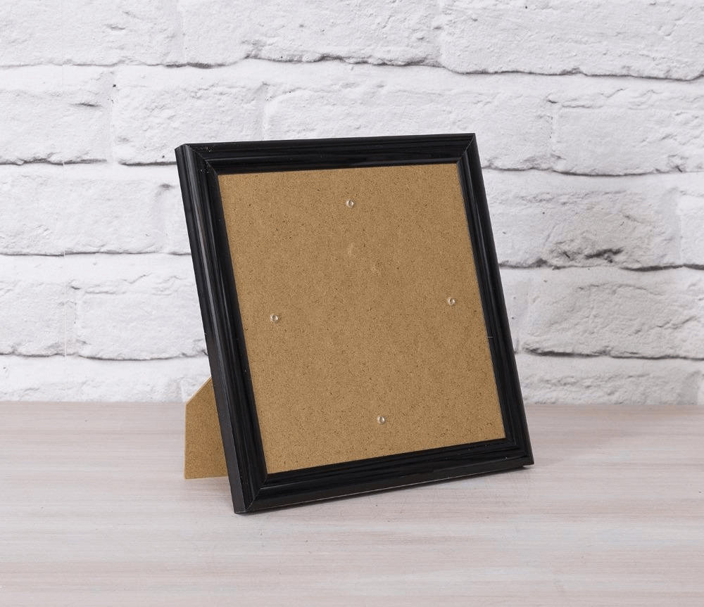 Black Crystal Art Greetings Card Frame, photographed on table against a white brick background
