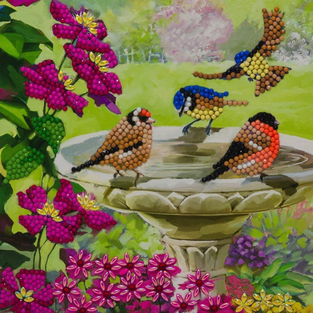 completed Craft Buddy Garden Birds Crystal Art greetings card kit - bird visiting a bird bath amongst flowers and foliage