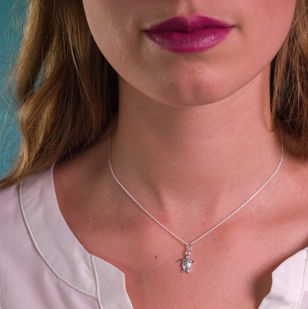 Model wearing Silver Origins Baby Turtle Pendant Necklace