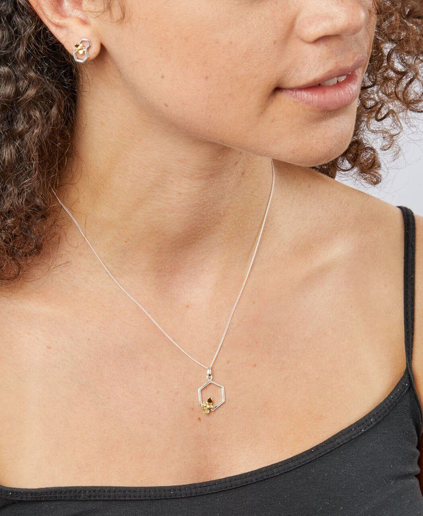 Model wearing Gold-Plated Bee & Single Honeycomb Pendant Necklace and complementary stud earrings